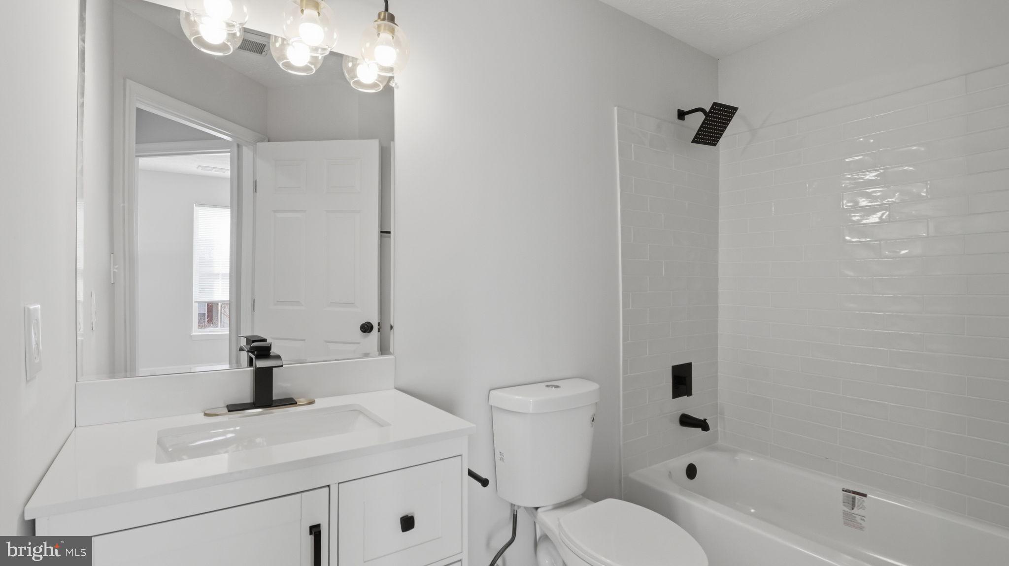1404 Pangbourne Way Hanover, MD 21076 - Photo 21 of 31 a bathroom with a sink a toilet and shower