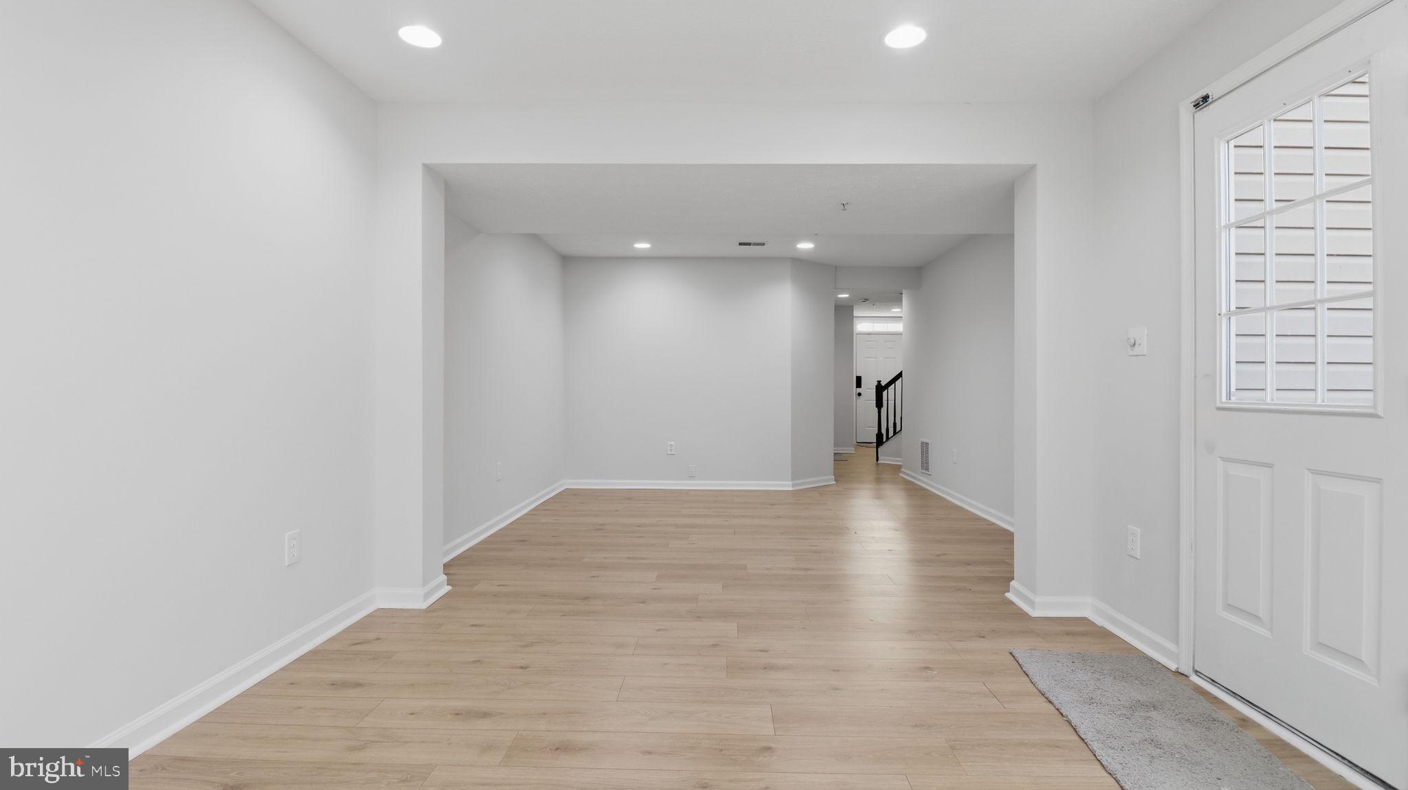 1404 Pangbourne Way Hanover, MD 21076 - Photo 25 of 31 a view of a hallway with wooden floor and a bathroom
