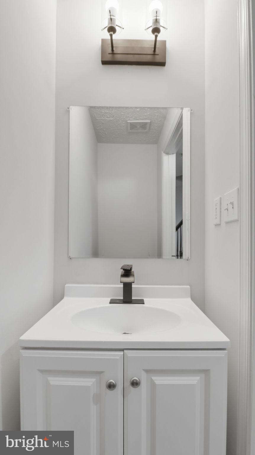 1404 Pangbourne Way Hanover, MD 21076 - Photo 26 of 31 a bathroom with a sink and a mirror