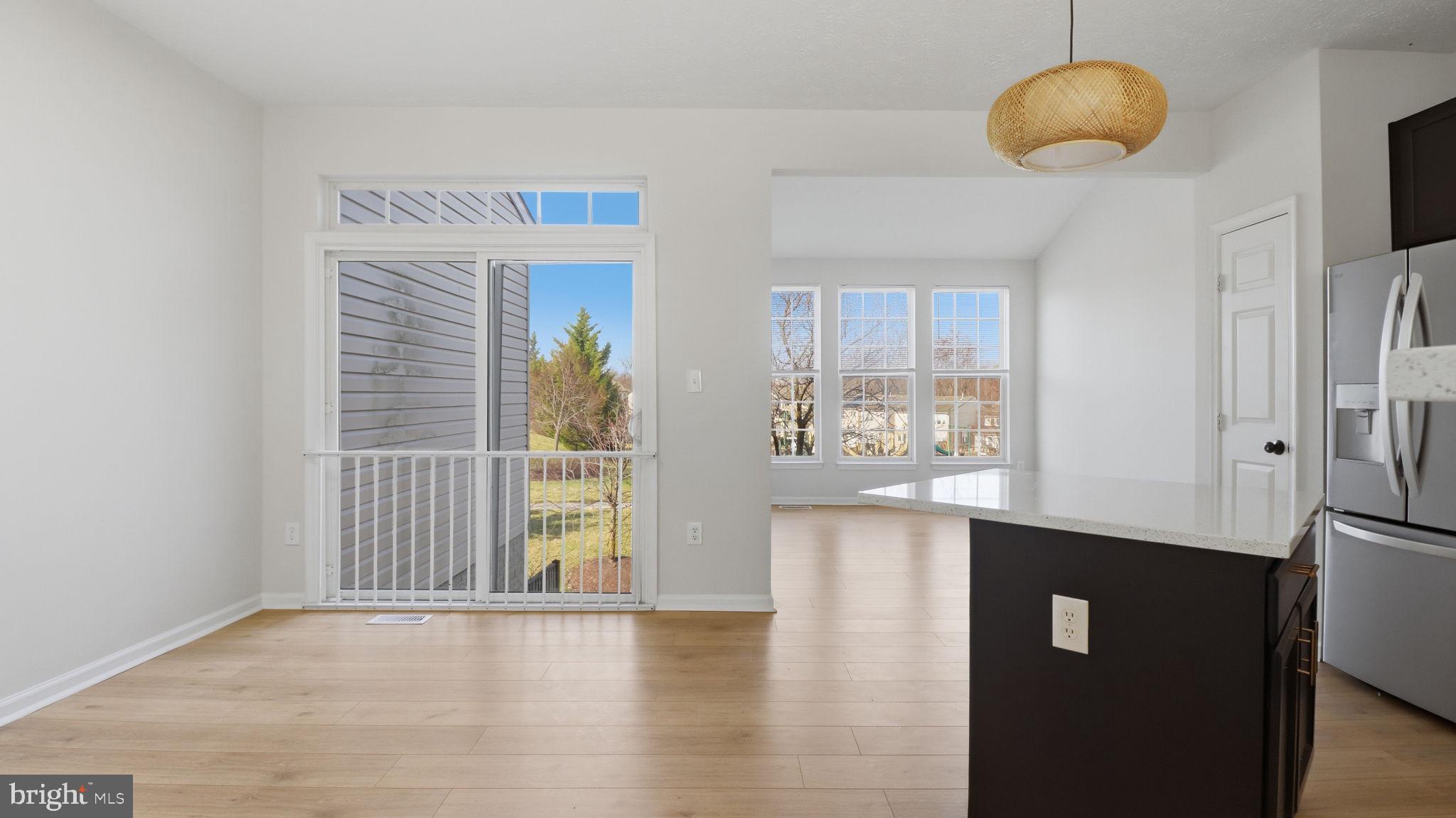 1404 Pangbourne Way Hanover, MD 21076 - Photo 5 of 31 a view of an empty room with window and kitchen view