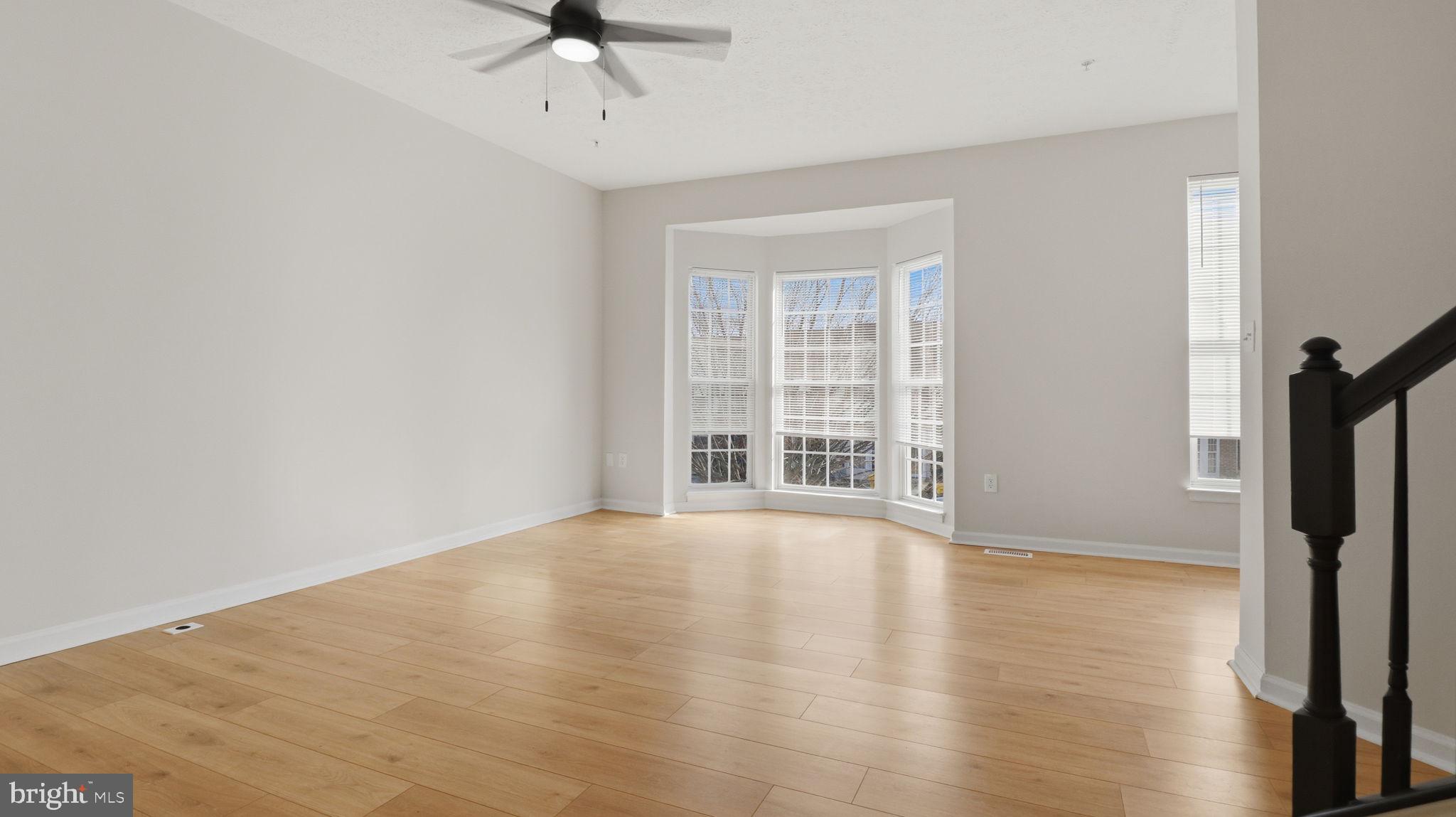 1404 Pangbourne Way Hanover, MD 21076 - Photo 8 of 31 wooden floor in an empty room with a window