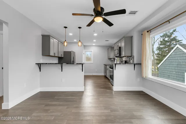 a view of kitchen with furniture and stainless steel appliances