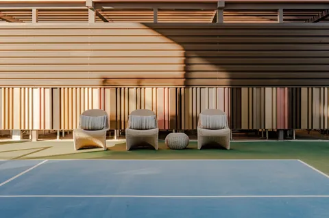 a view of a patio with a table and chairs and a barbeque