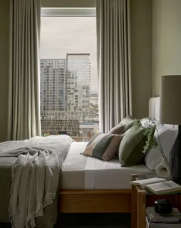 a bedroom with a bed and a window