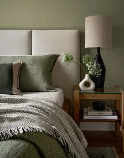 a bedroom with a bed and lamp
