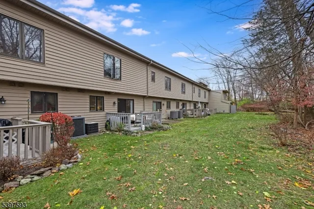 a view of a house with a yard and sitting area