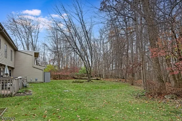 a view of house with backyard