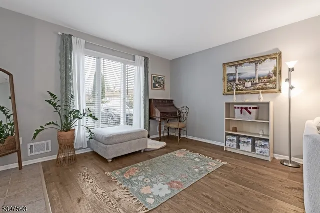 a living room with furniture and a book shelf