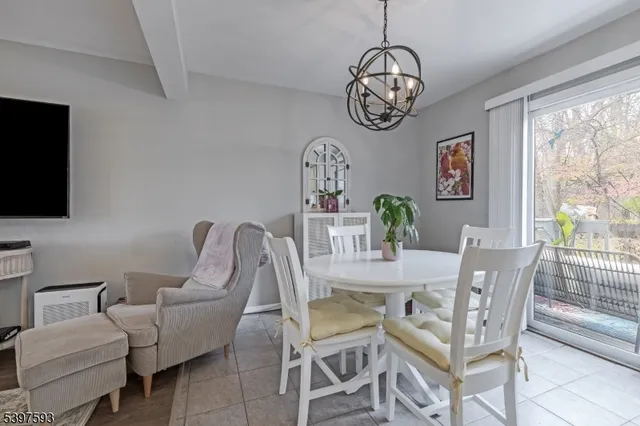 a living room with furniture a flat screen tv and a large window