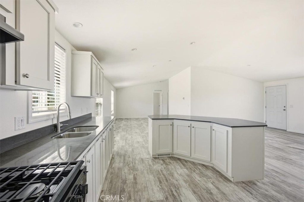 9622 Via Verde Avenue Pinon Hills, CA 92372 - Photo 15 of 48 a kitchen with granite countertop a stove and a sink