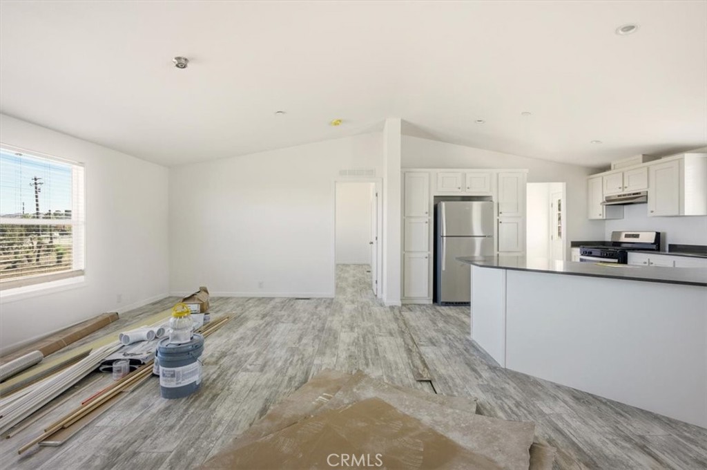 9622 Via Verde Avenue Pinon Hills, CA 92372 - Photo 39 of 48 a kitchen with a refrigerator and white cabinets