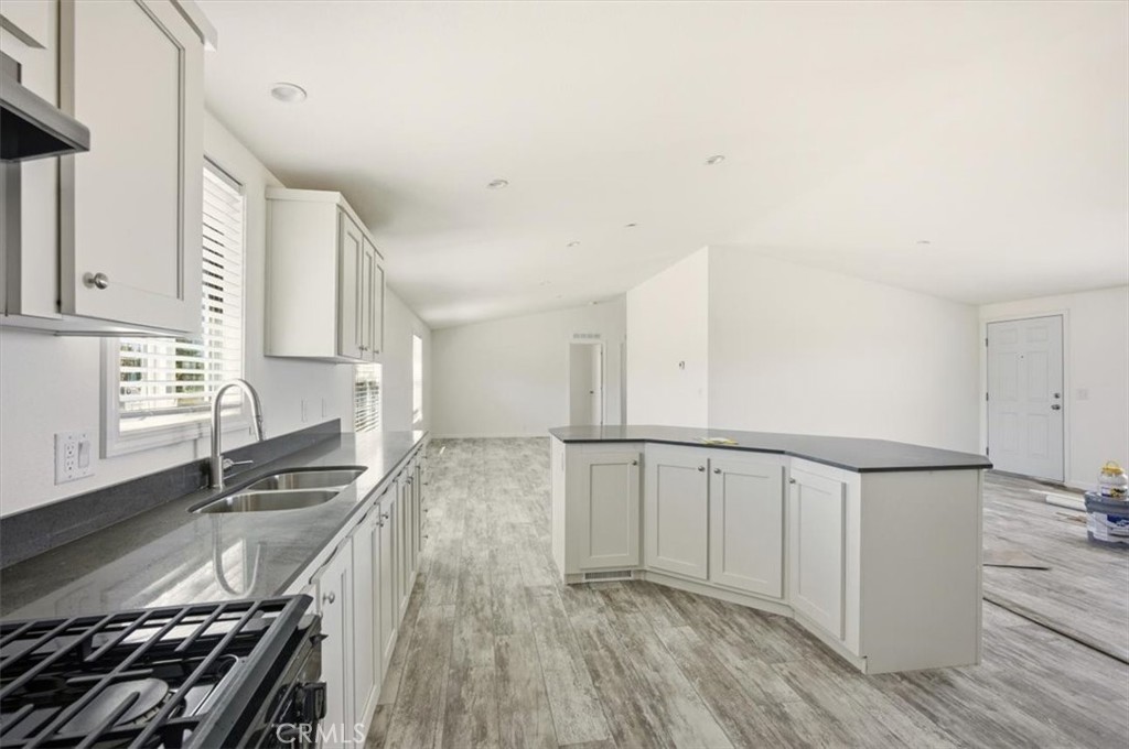 9622 Via Verde Avenue Pinon Hills, CA 92372 - Photo 41 of 48 a kitchen with granite countertop a stove and a sink