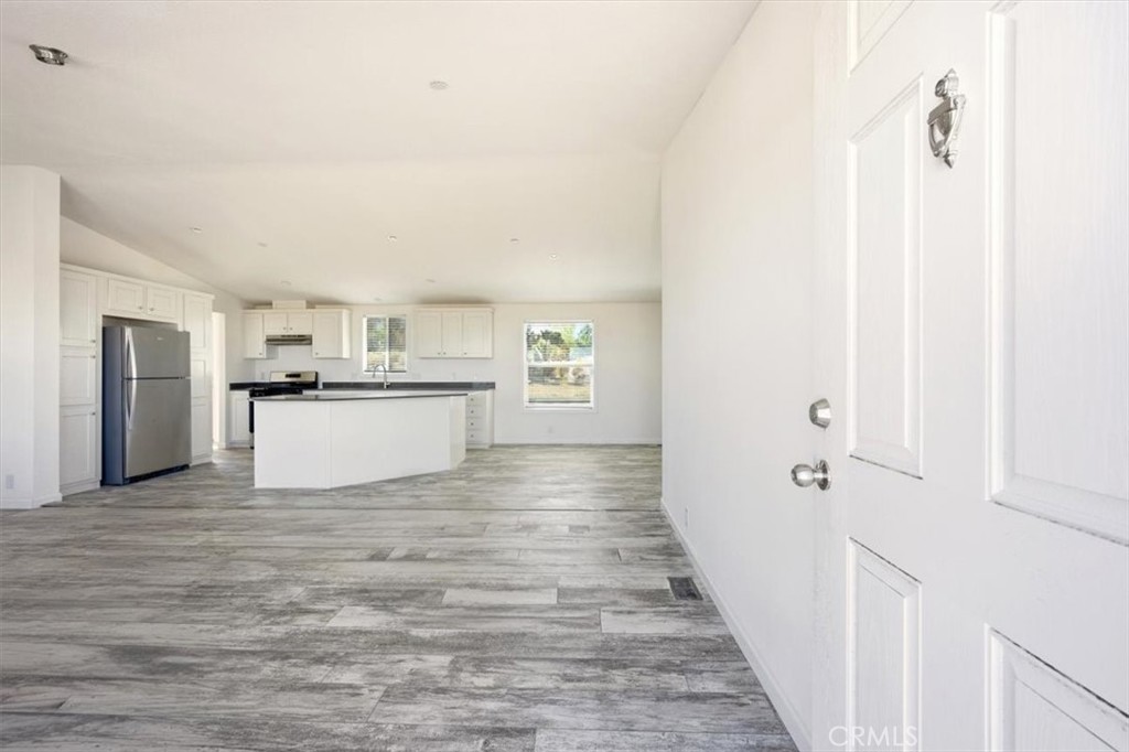 9622 Via Verde Avenue Pinon Hills, CA 92372 - Photo 8 of 48 a view of a kitchen with wooden floor and electronic appliances