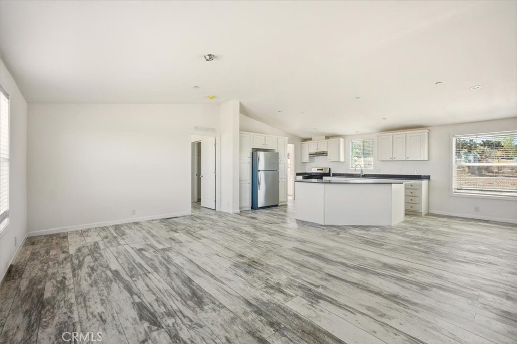 9622 Via Verde Avenue Pinon Hills, CA 92372 - Photo 9 of 48 a view of a kitchen with wooden floor and a kitchen