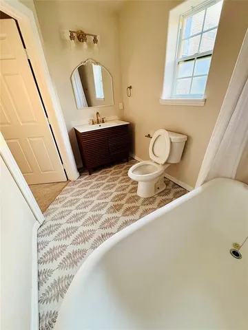 a bathroom with a sink and mirror with bathtub
