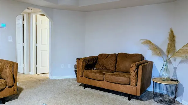 a living room with furniture and a potted plant