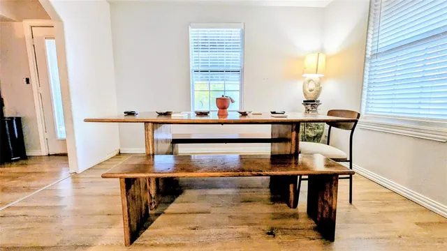 a view of dining table chairs and window