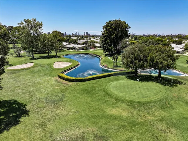 an aerial view of a tennis ground and a cars park side of the road