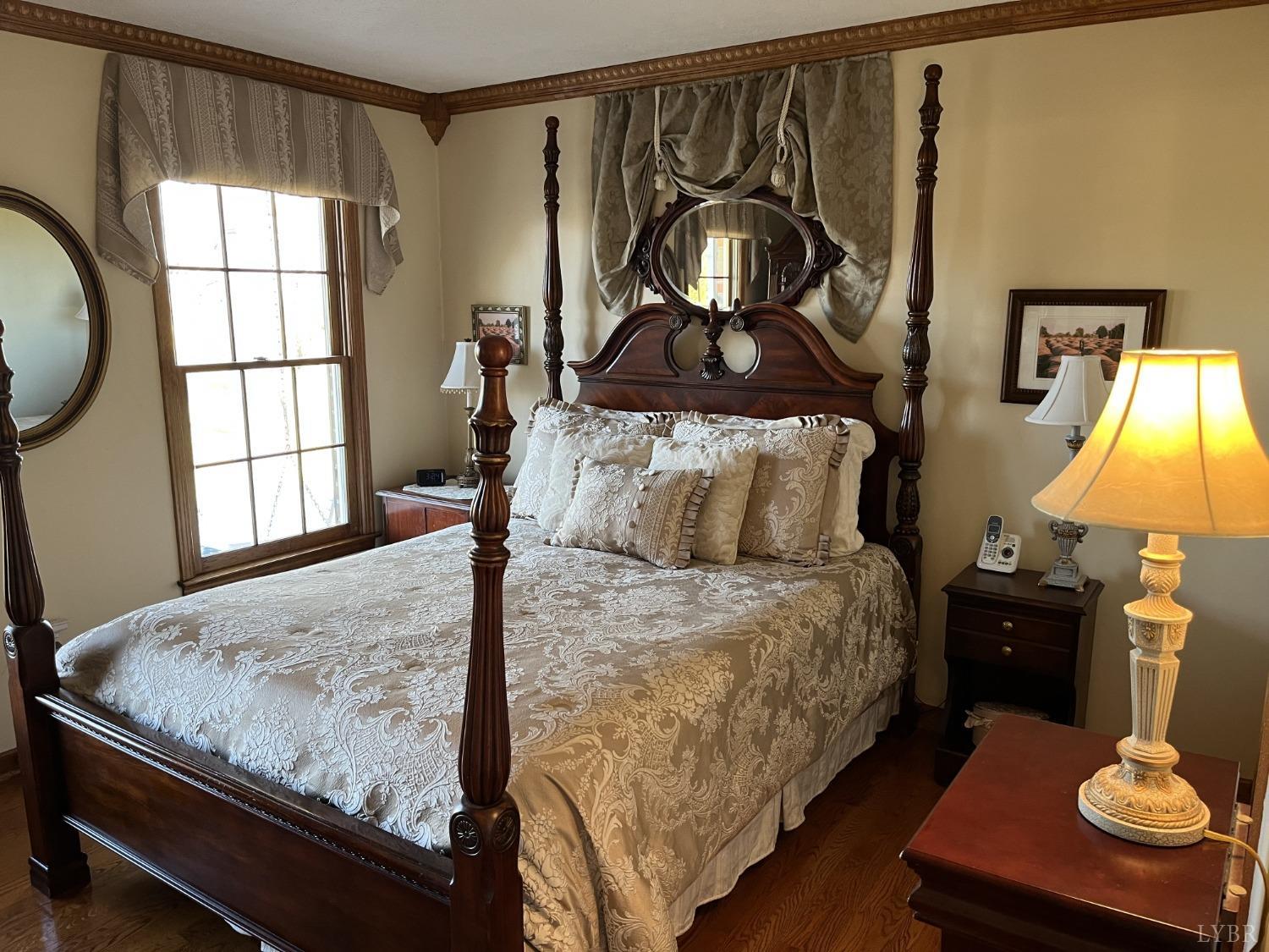 3912 Lowry Road Goode, VA 24556 - Photo 15 of 56 a bed sitting in a bedroom next to a window