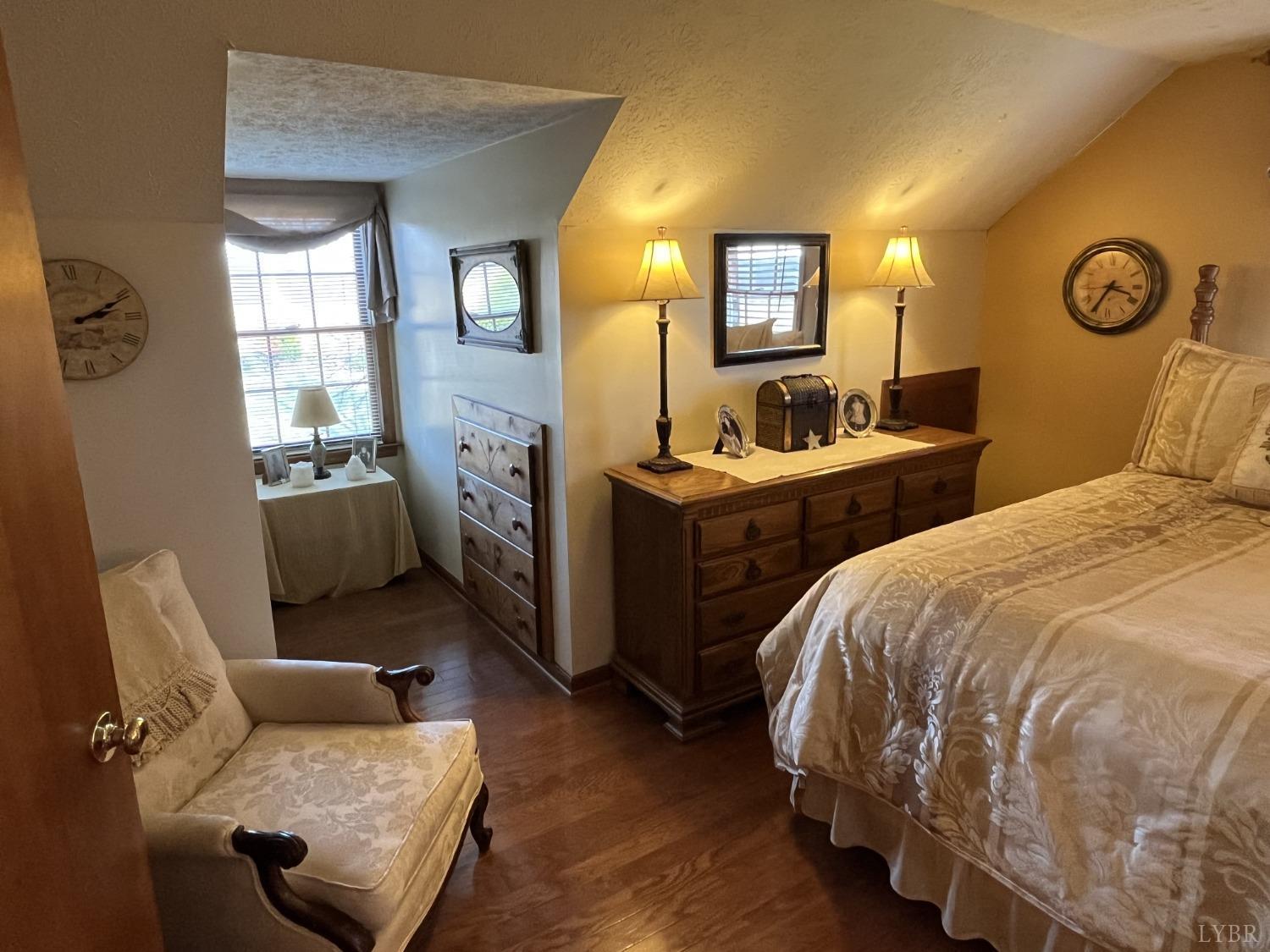 3912 Lowry Road Goode, VA 24556 - Photo 23 of 56 a bedroom with a bed and wooden floor