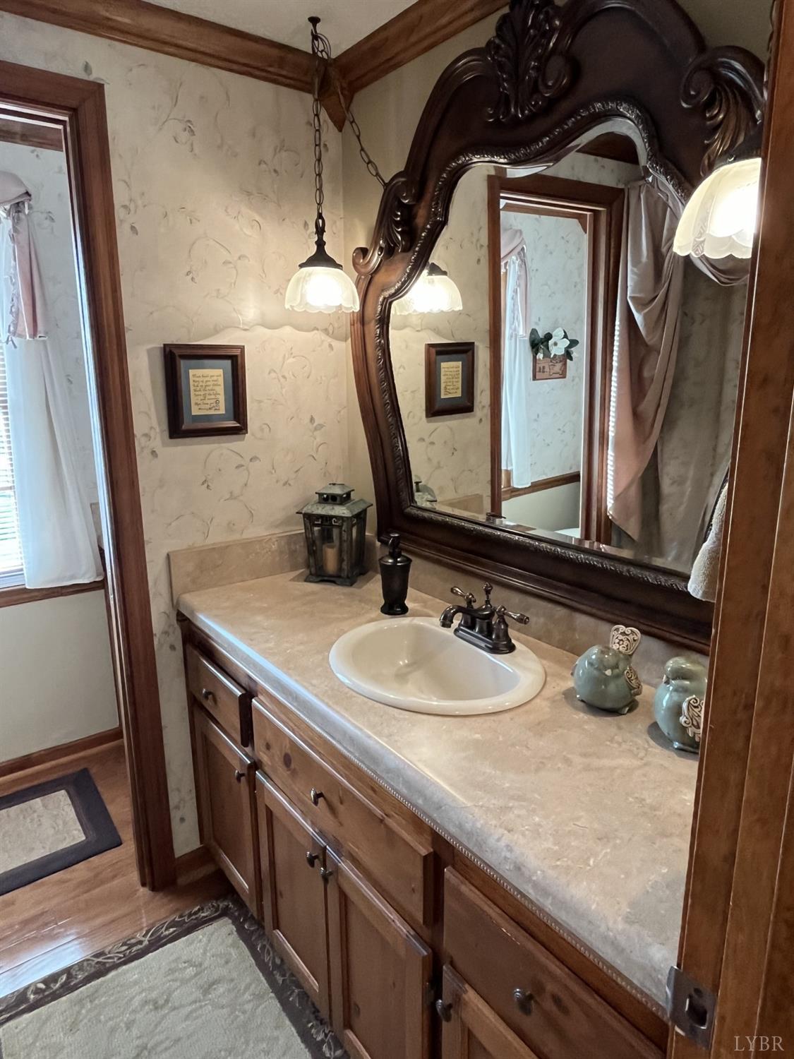 3912 Lowry Road Goode, VA 24556 - Photo 24 of 56 a bathroom with a granite countertop sink a mirror and vanity