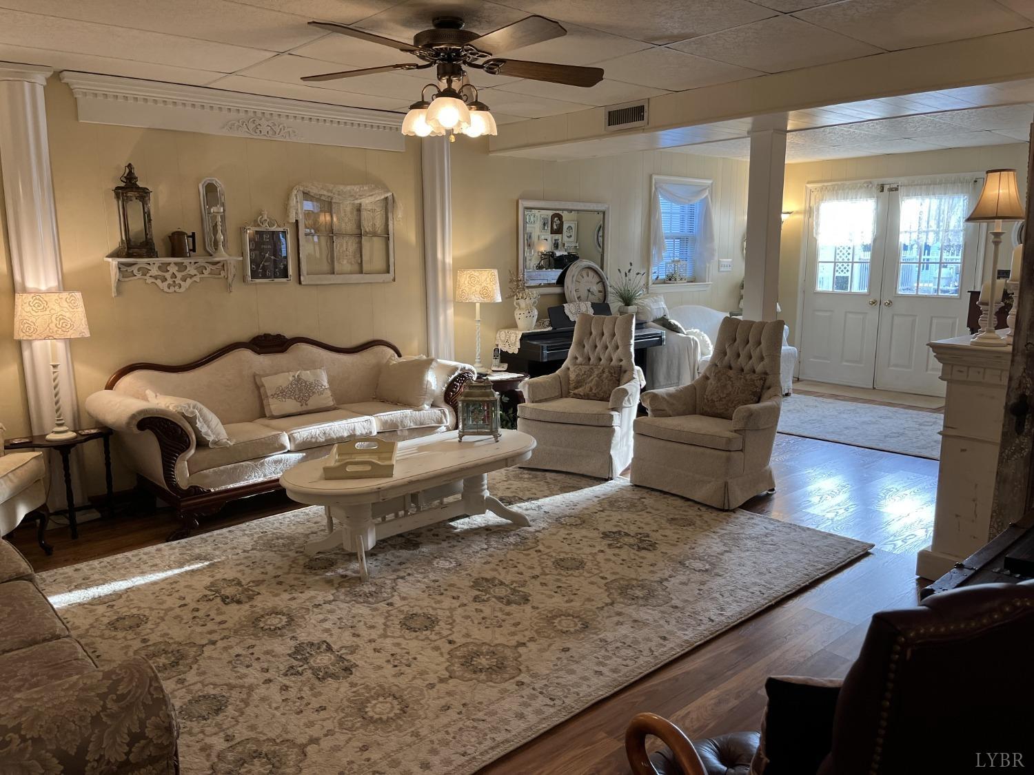 3912 Lowry Road Goode, VA 24556 - Photo 27 of 56 a living room with furniture and a chandelier