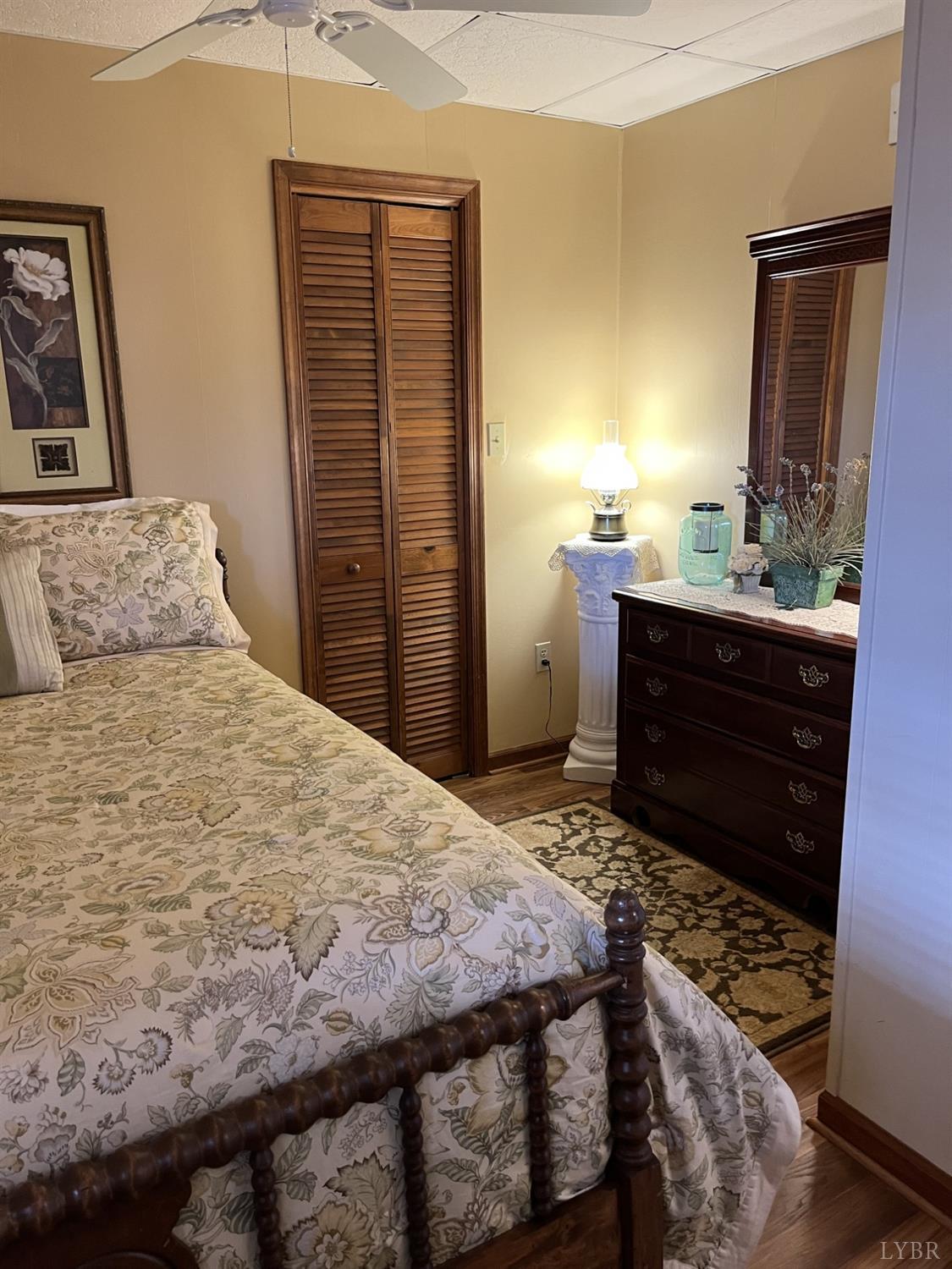 3912 Lowry Road Goode, VA 24556 - Photo 34 of 56 a bedroom with a bed and a mirror on dresser