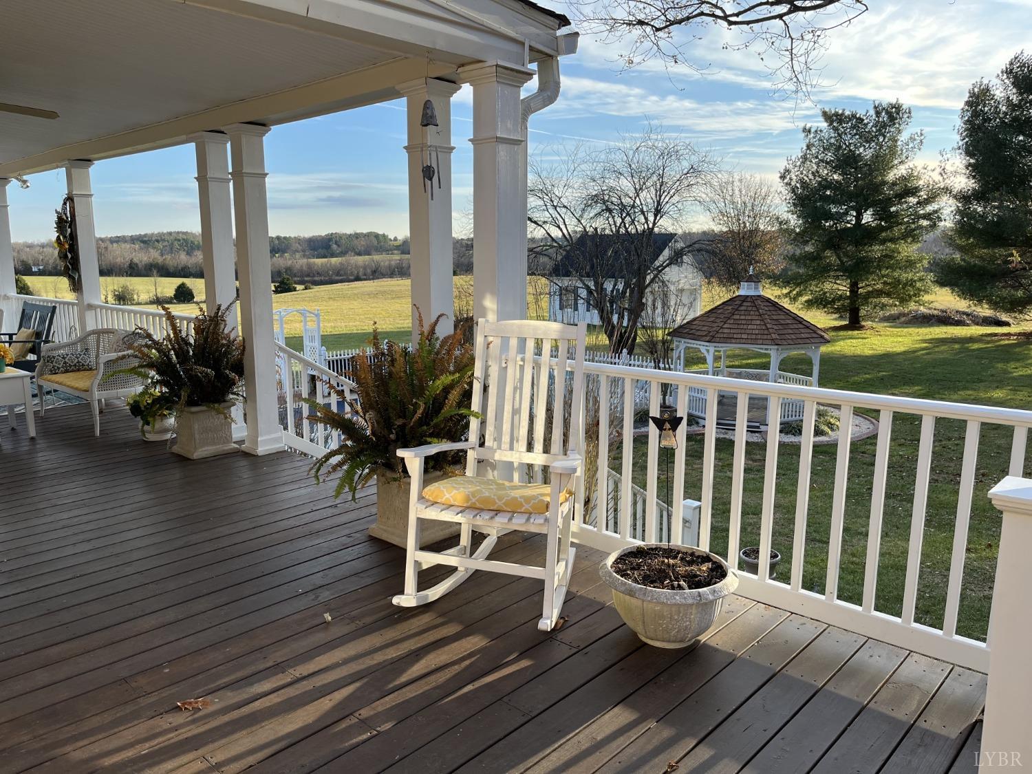 3912 Lowry Road Goode, VA 24556 - Photo 40 of 56 a view of a deck with table and chairs and wooden floor