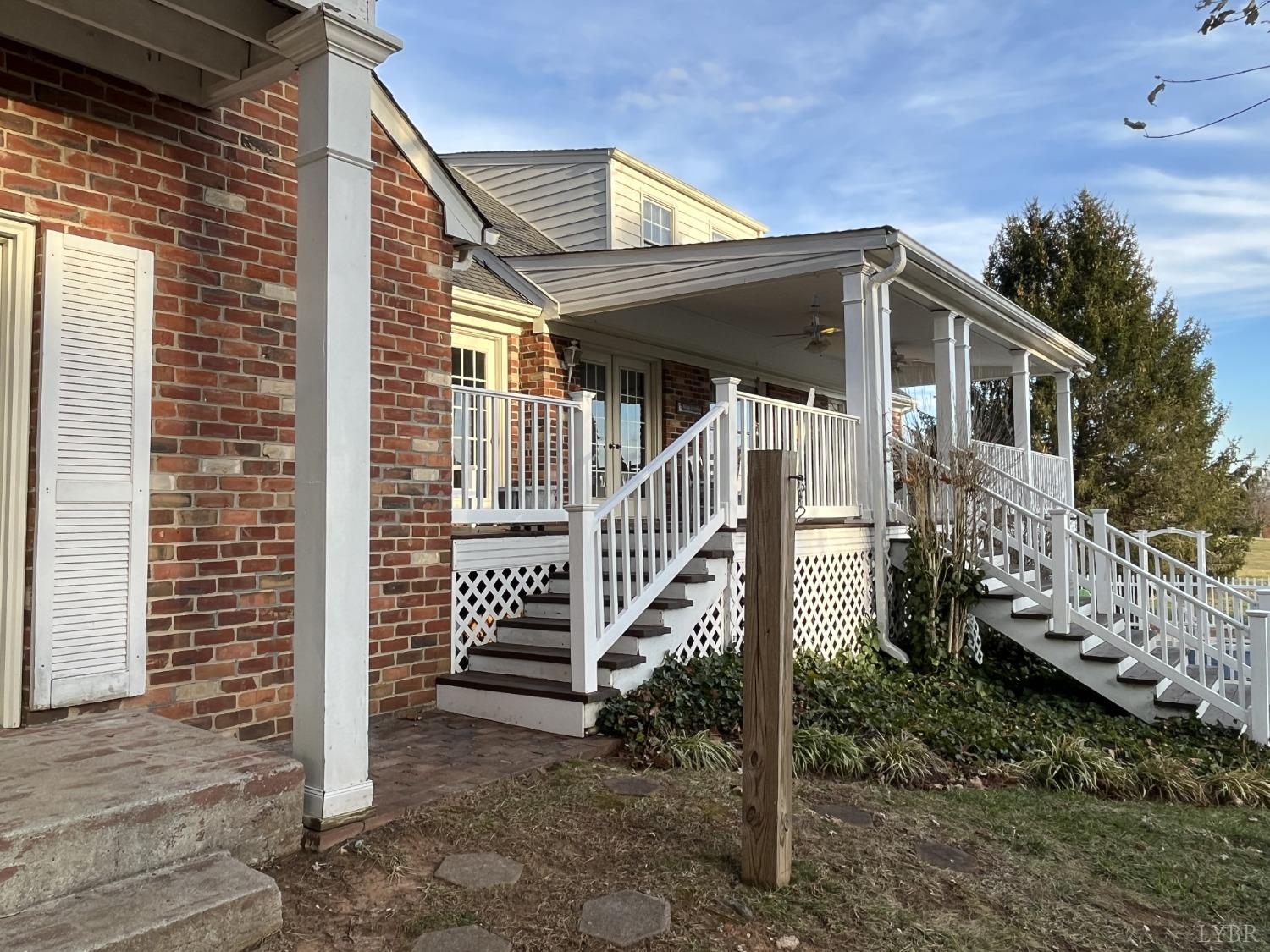 3912 Lowry Road Goode, VA 24556 - Photo 41 of 56 a view of a house with wooden fence and a porch