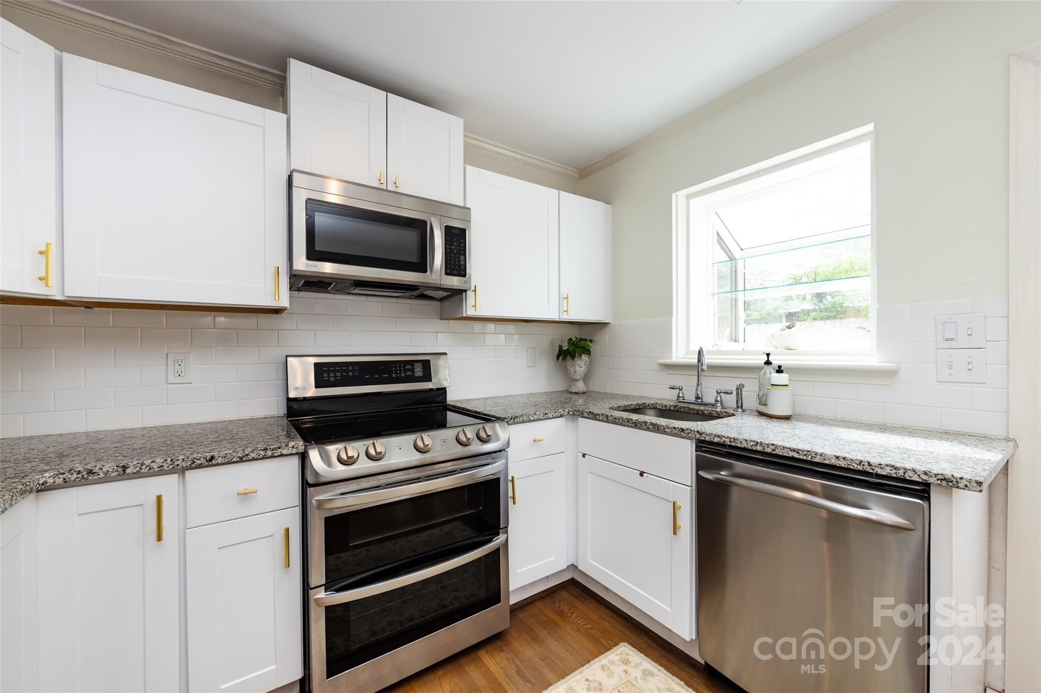 4820 Murrayhill Road Charlotte, NC 28209 - Photo 11 of 31 a kitchen with stainless steel appliances granite countertop a sink dishwasher a stove and a microwave oven with cabinets