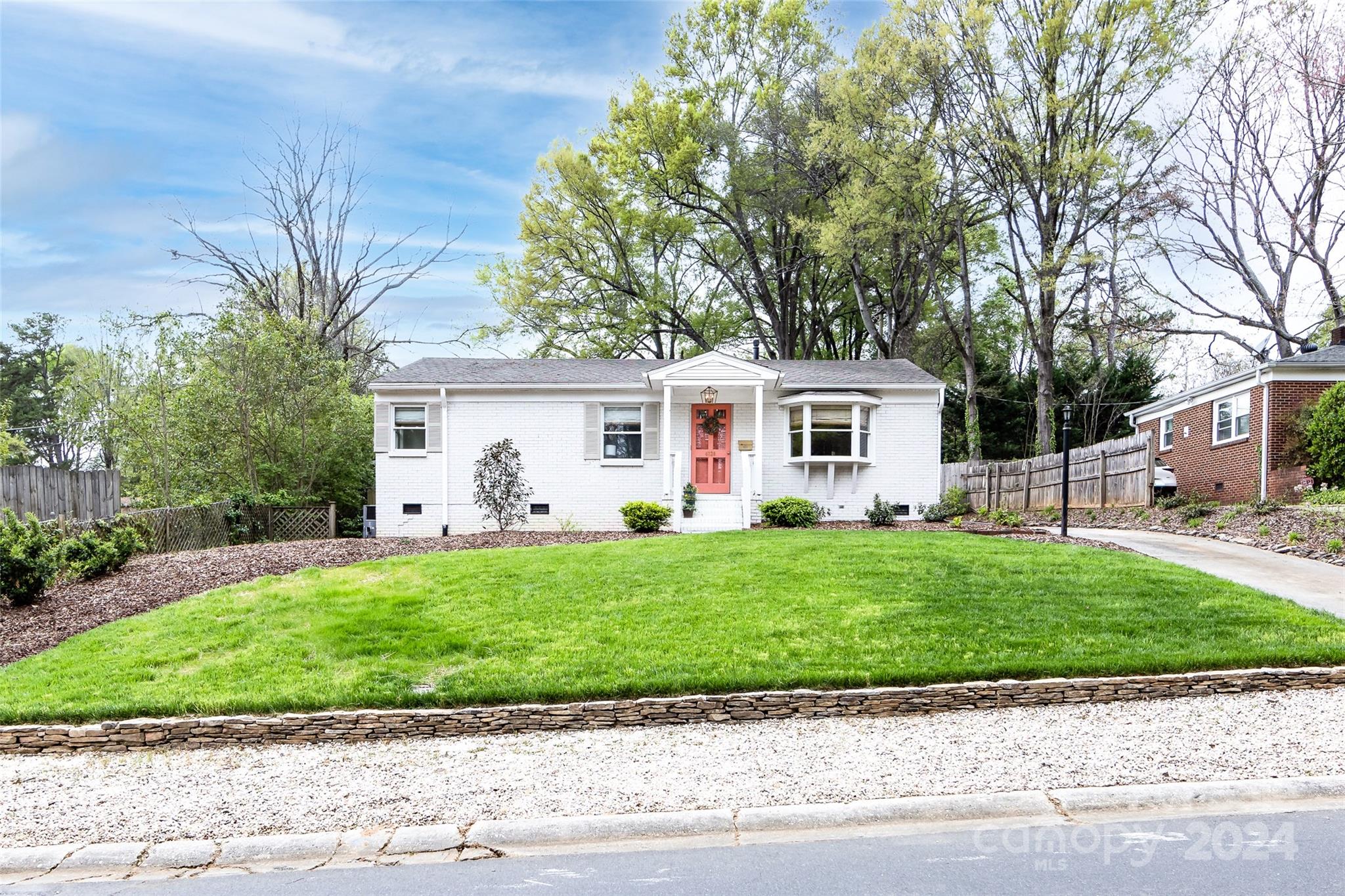 4820 Murrayhill Road Charlotte, NC 28209 - Photo 2 of 31 a front view of a house with a garden and a tree