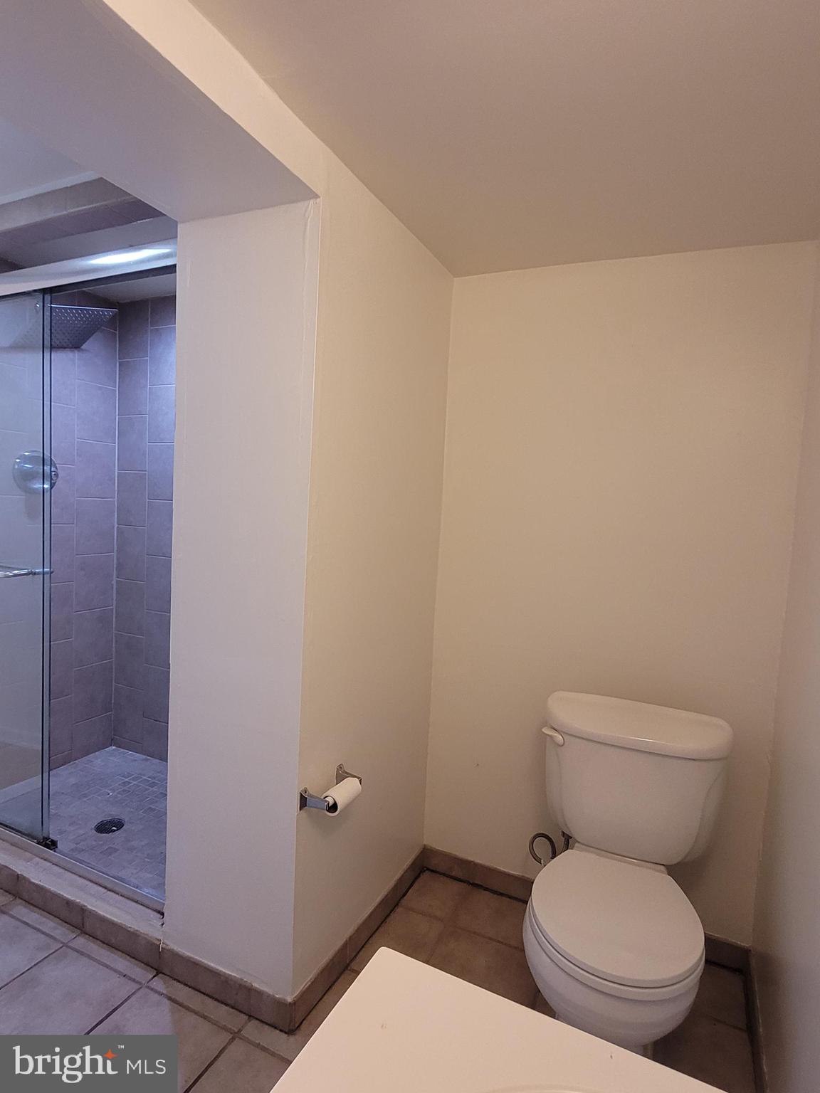 2015 Chestnut Street, Unit 2F Philadelphia, PA 19103 - Photo 14 of 16 a white toilet sitting next to a shower