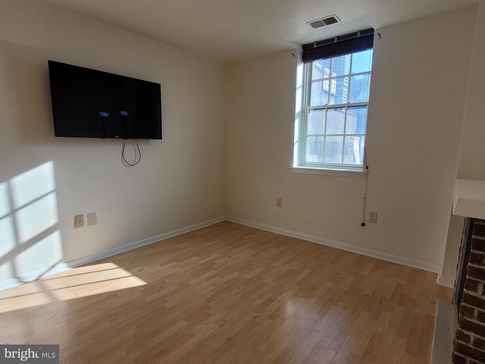 2015 Chestnut Street, Unit 2F Philadelphia, PA 19103 - Photo 4 of 16 a view of room with window and flat screen tv