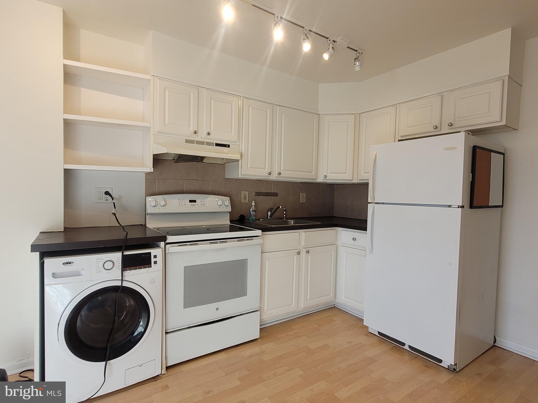 2015 Chestnut Street, Unit 2F Philadelphia, PA 19103 - Photo 6 of 16 a kitchen with a refrigerator sink stove and cabinets