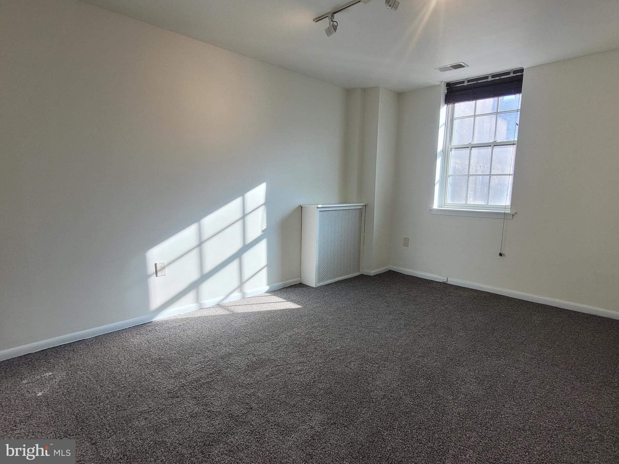 2015 Chestnut Street, Unit 2F Philadelphia, PA 19103 - Photo 8 of 16 an empty room with windows
