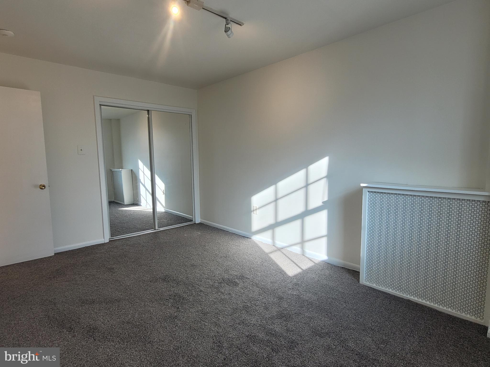 2015 Chestnut Street, Unit 2F Philadelphia, PA 19103 - Photo 9 of 16 an empty room with windows and closet