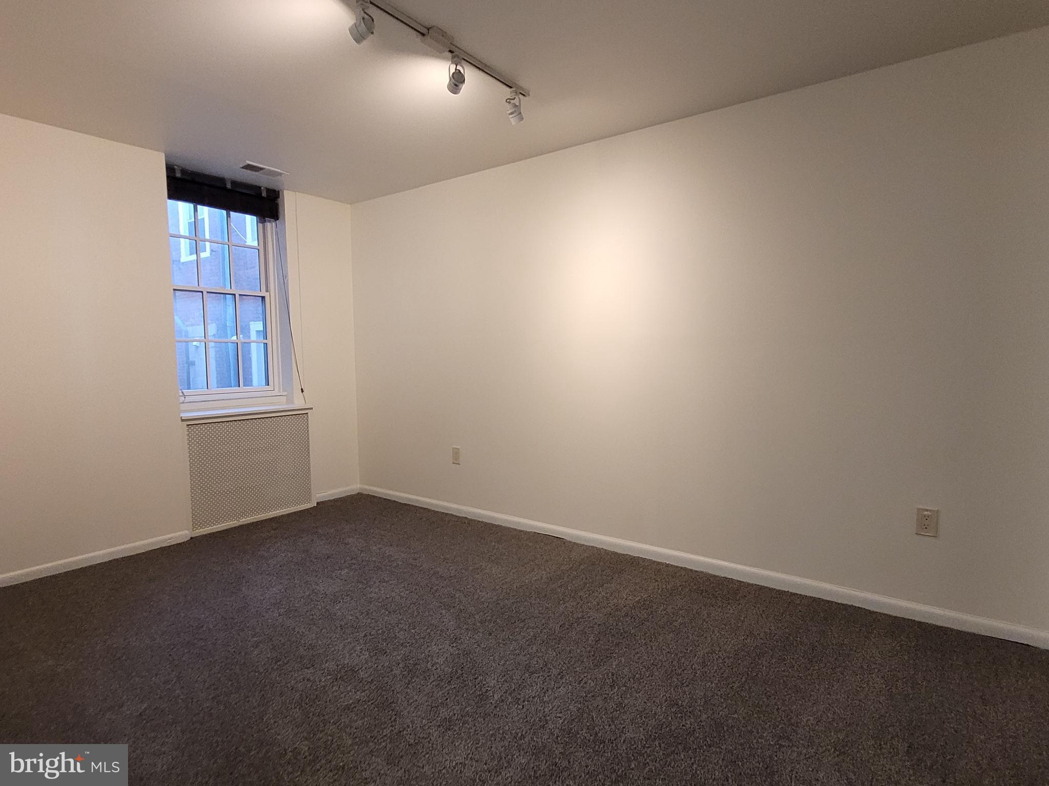 2015 Chestnut Street, Unit 2F Philadelphia, PA 19103 - Photo 10 of 16 an empty room with windows
