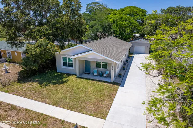 a aerial view of a house with a yard
