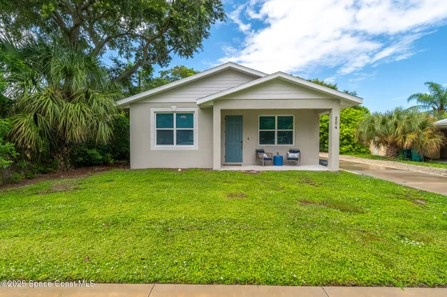 a front view of house with yard and green space