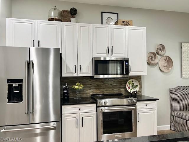 3411 Sandpiper Way Naples, FL 34109 - Photo 11 of 35 a kitchen with a stove and a refrigerator