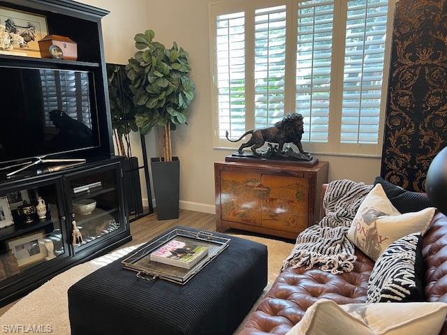3411 Sandpiper Way Naples, FL 34109 - Photo 15 of 35 a living room with furniture and a flat screen tv