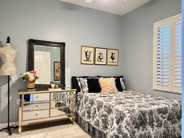 3411 Sandpiper Way Naples, FL 34109 - Photo 20 of 35 a bedroom with a bed and a dresser