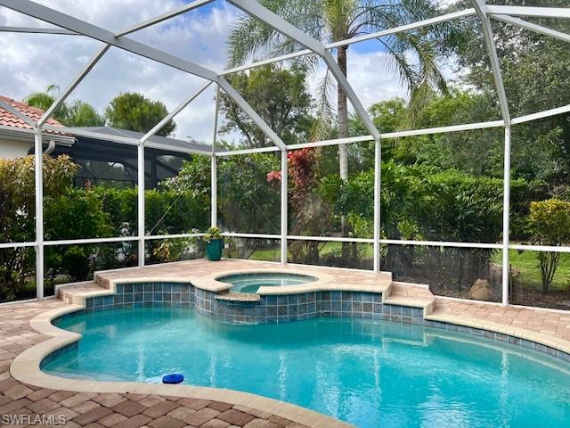 3411 Sandpiper Way Naples, FL 34109 - Photo 2 of 35 a view of a swimming pool with a yard