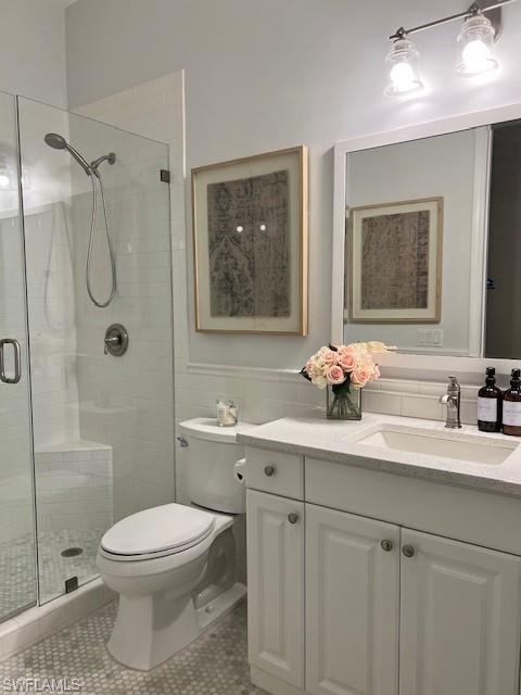 3411 Sandpiper Way Naples, FL 34109 - Photo 21 of 35 a bathroom with a toilet a sink and shower