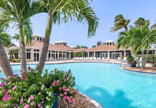 3411 Sandpiper Way Naples, FL 34109 - Photo 30 of 35 a front view of a house with swimming pool having outdoor seating