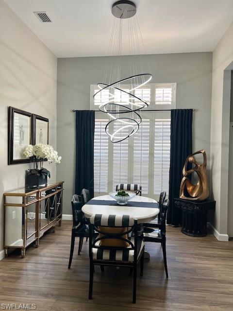 3411 Sandpiper Way Naples, FL 34109 - Photo 7 of 35 a view of a dining room with furniture window and wooden floor