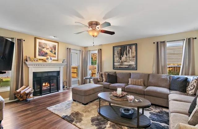 a living room with furniture a fireplace and a flat screen tv