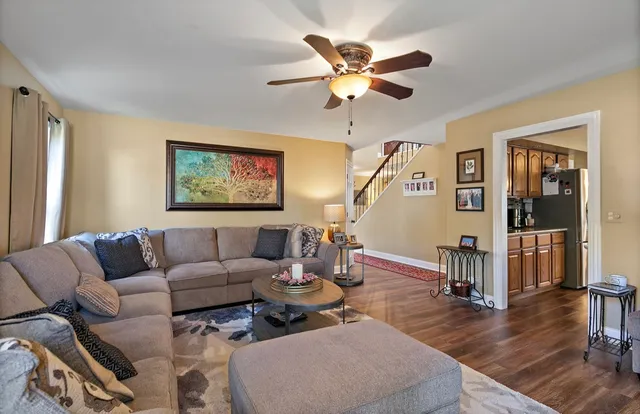a living room with furniture and a wooden floor