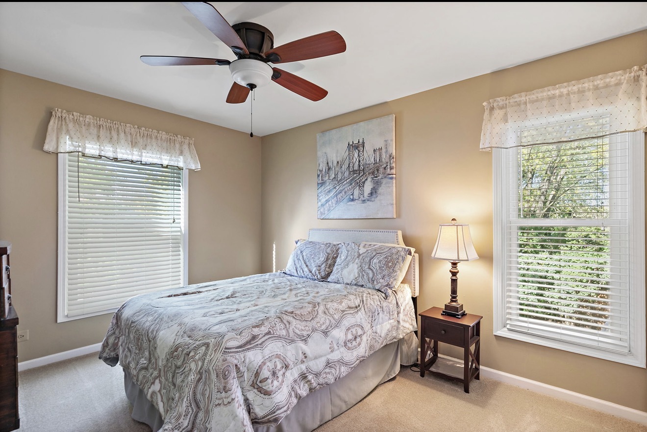 11612 Becky Lee Huntley, IL 60142 - Photo 19 of 33 a bedroom with a bed and a large window