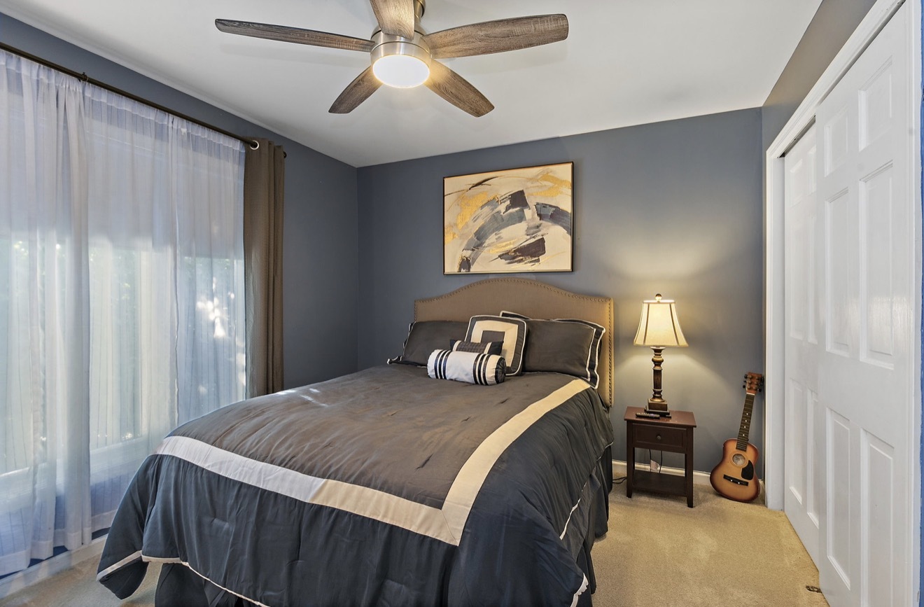 11612 Becky Lee Huntley, IL 60142 - Photo 21 of 33 a bedroom with a bed and a chandelier